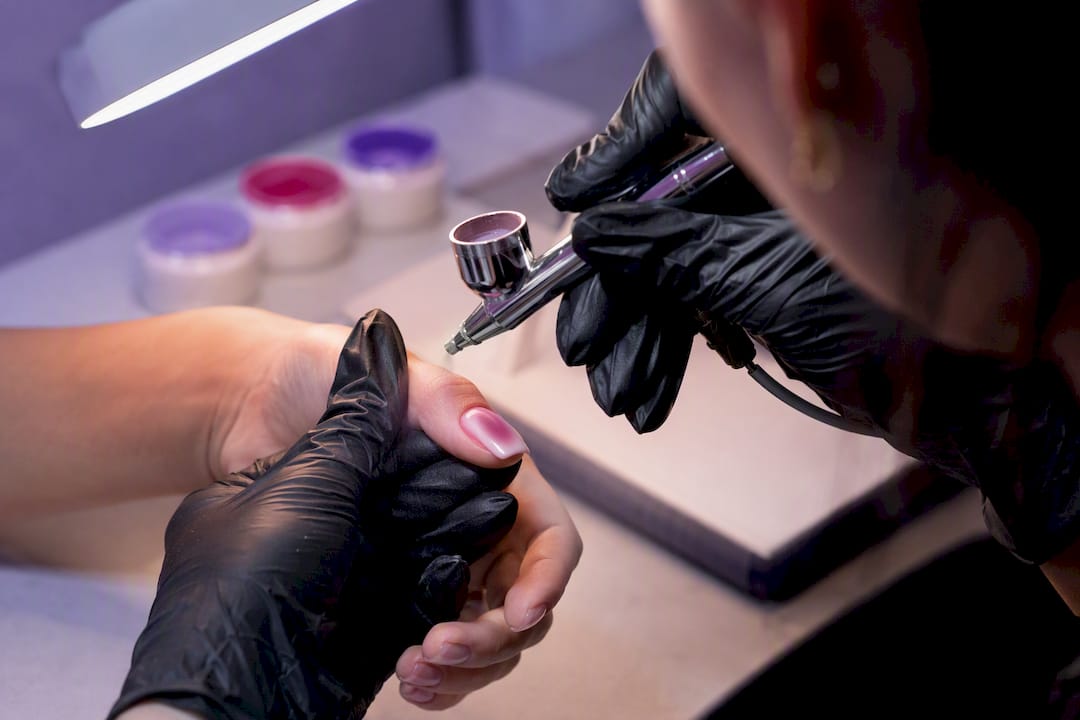 Technician airbrushing a smooth aura halo