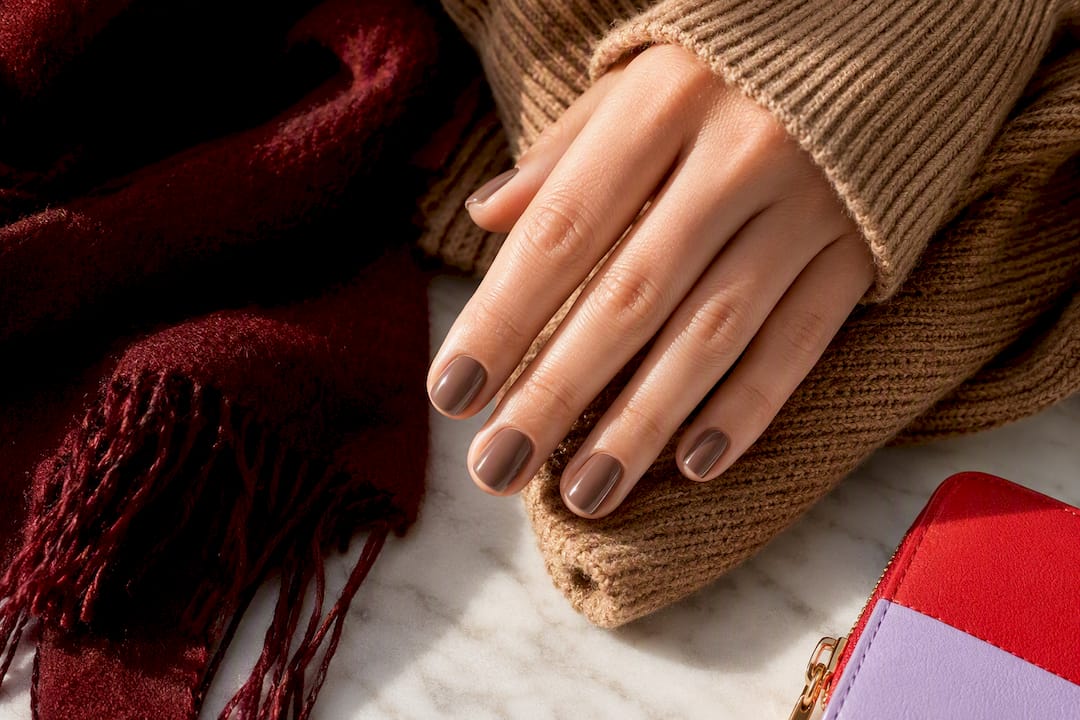 Iced mocha nails beside warm winter knitwear