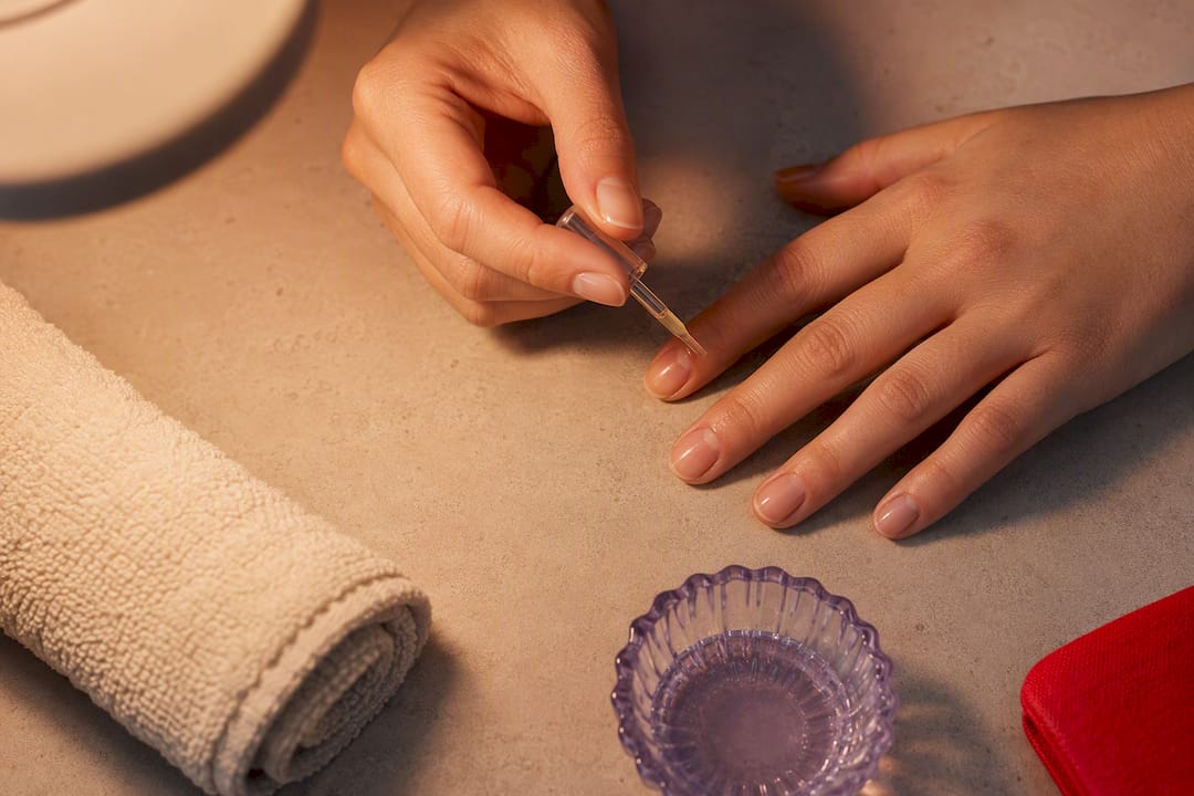 Cuticle oil applied around nail edge