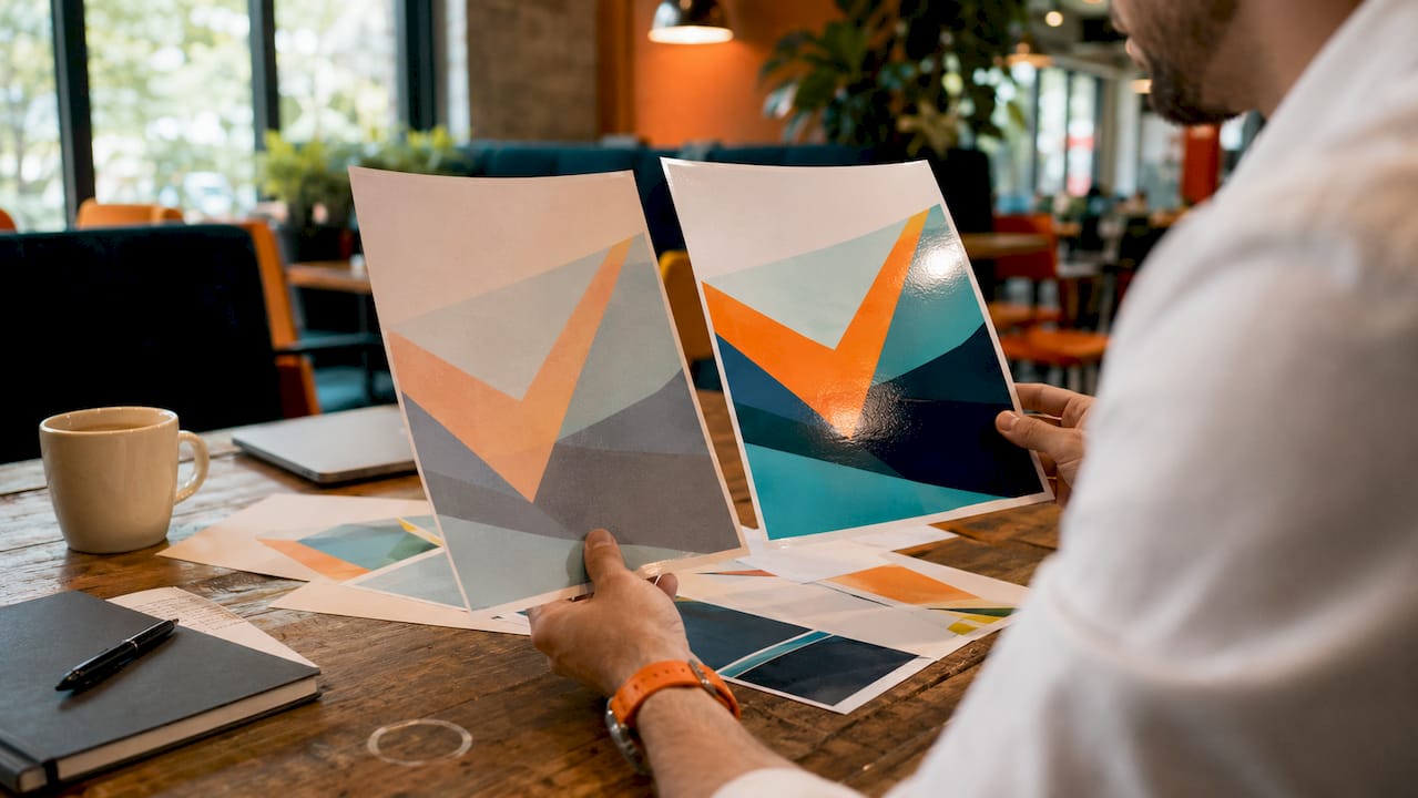 Hands comparing print quality differences