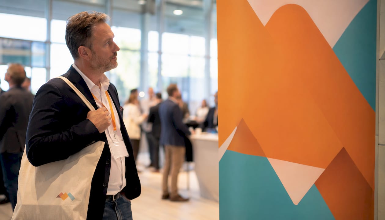 Business attendee noticing colorful trade show banner