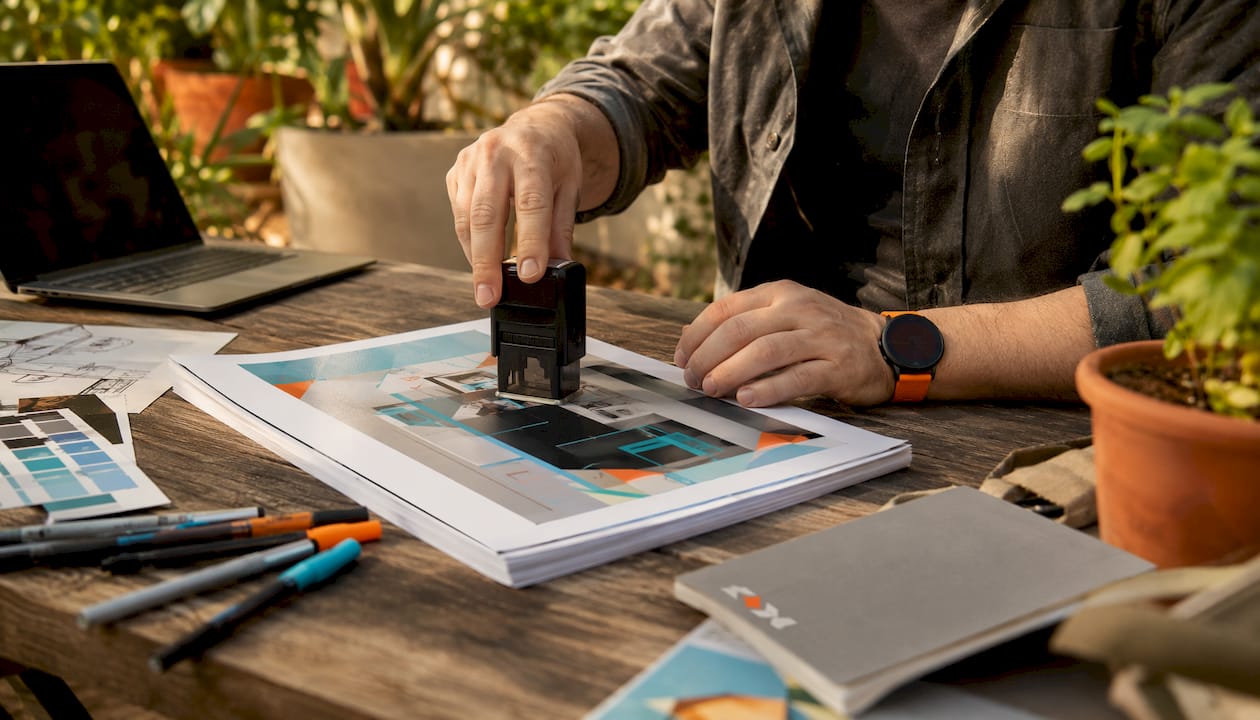 Hands approving trade show print artwork proof