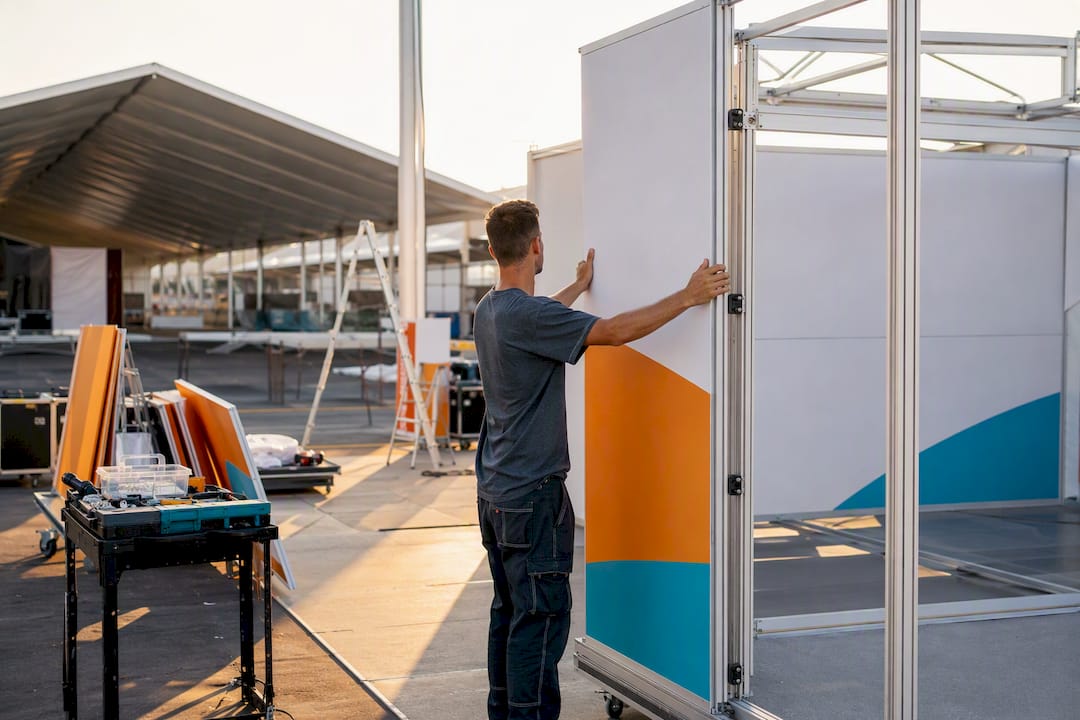 Technician fitting exhibition stand panel