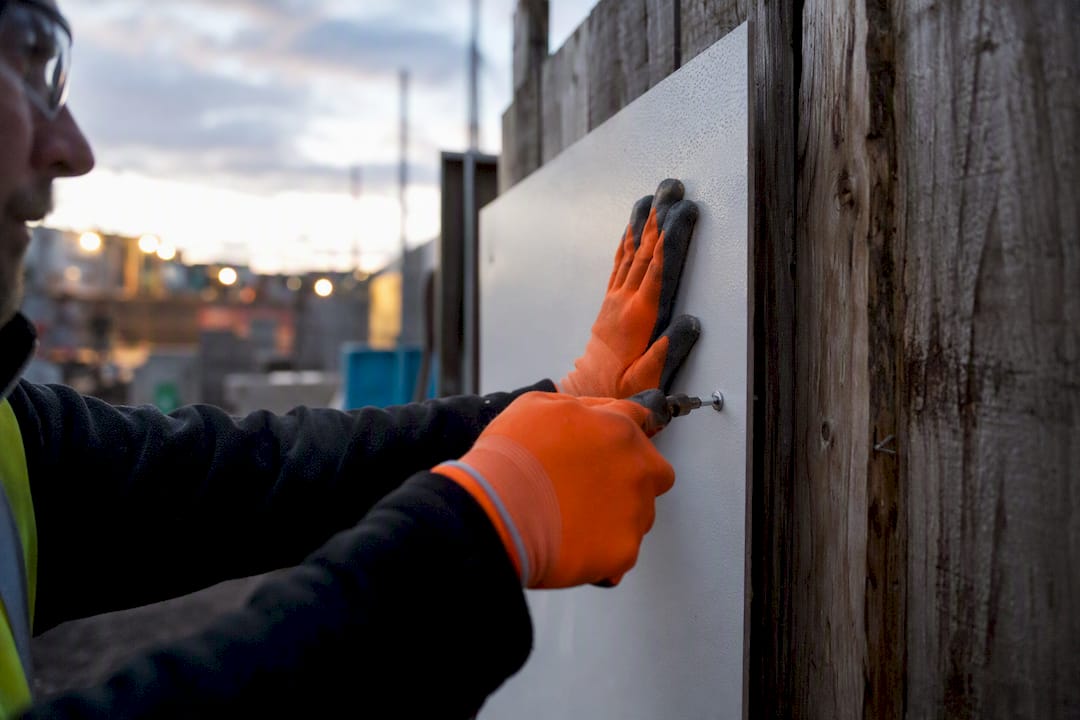 Hand installing durable site safety board