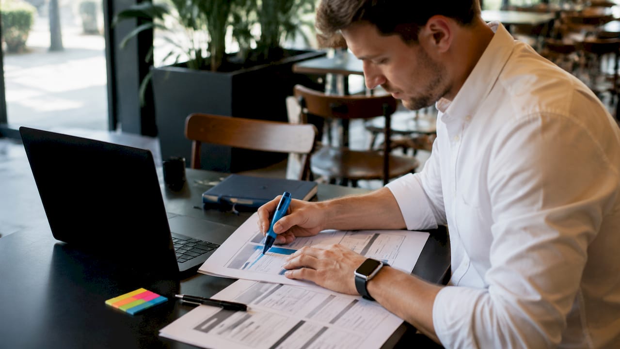 Hands arranging webpage header tag layouts on desk