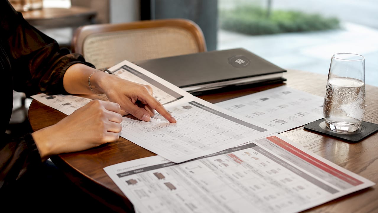 Hands pointing at event furniture pricing charts