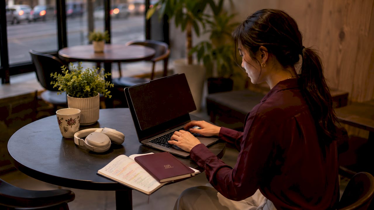 Study desk with laptop, privacy screen, and headphones