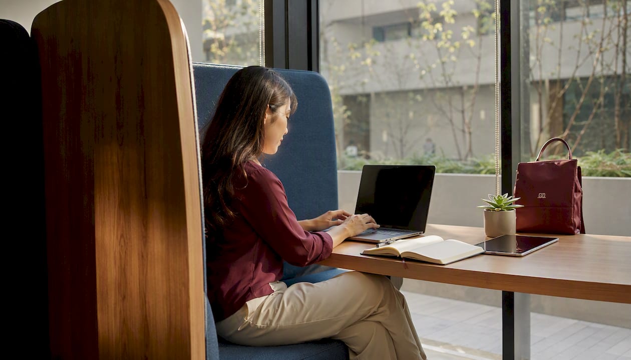 User sitting in booth for screen privacy
