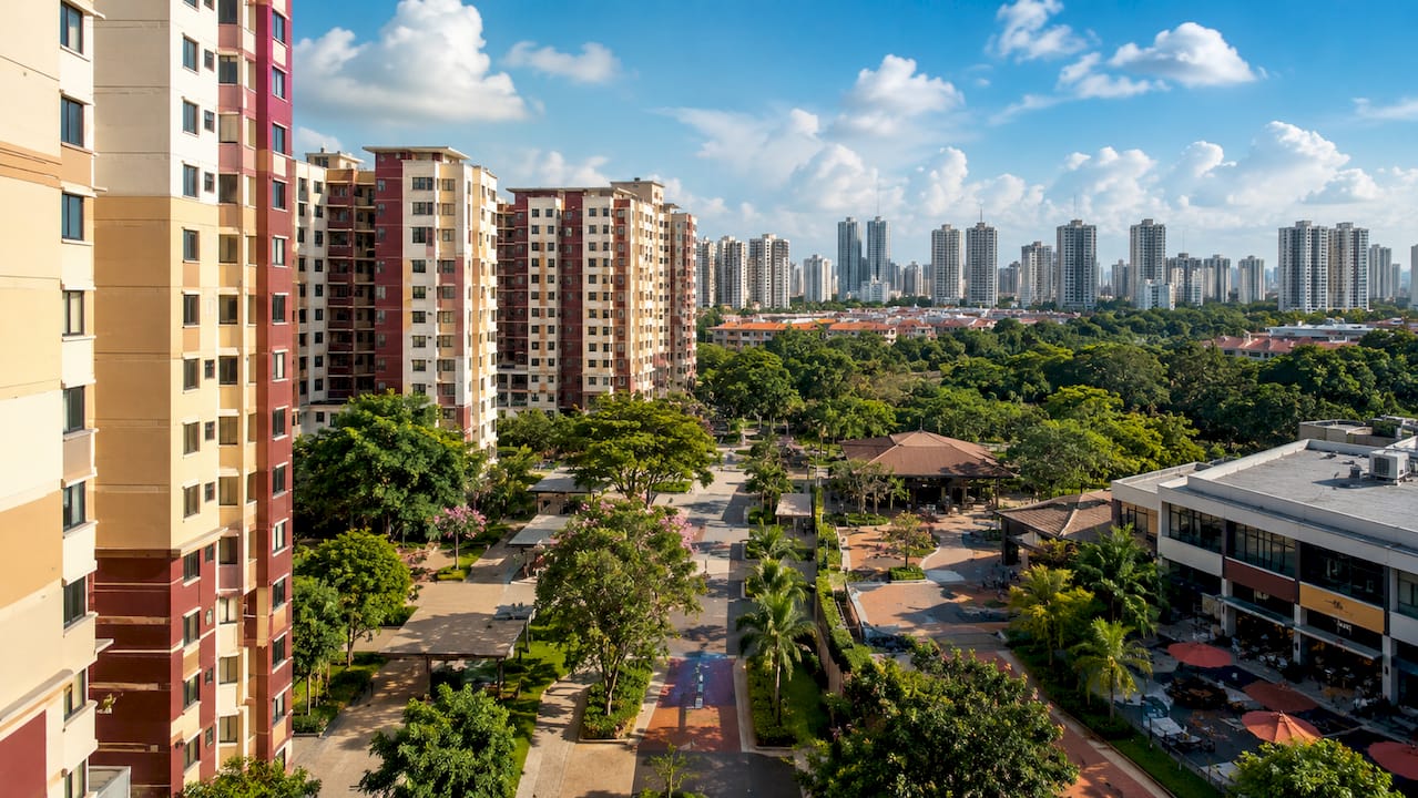 Singapore HDB and condo buildings with tropical greenery