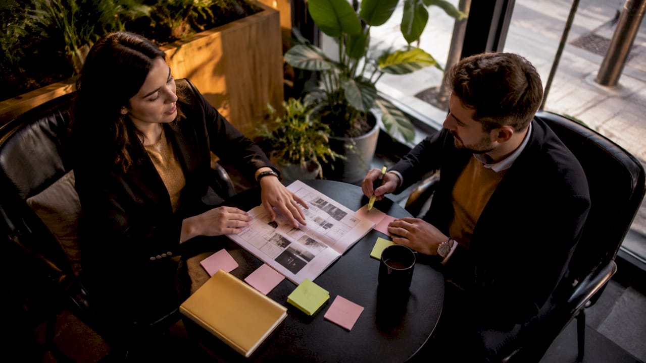 Two colleagues discussing iGaming partnership plans