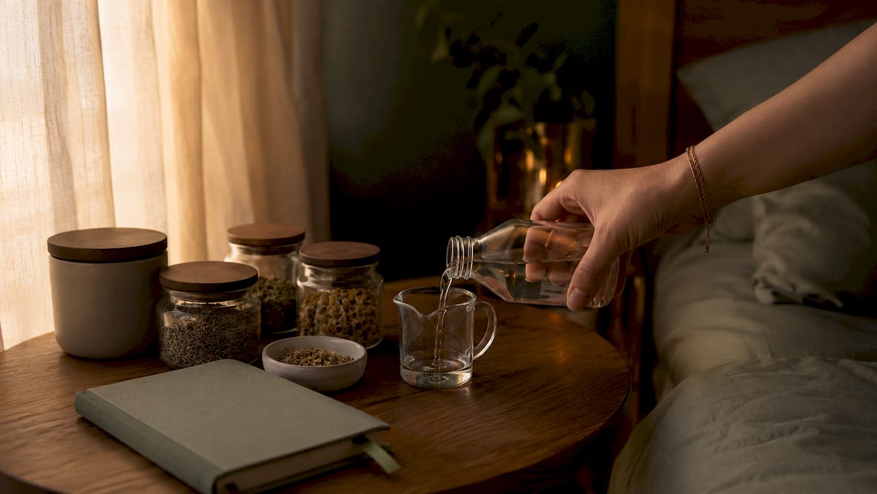 Close-up of hand measuring THC sleep drink dose