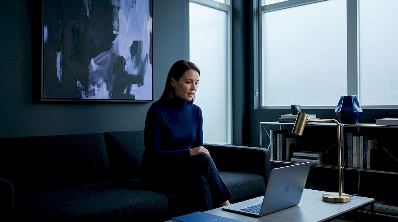 Person using offline AI assistant on Mac in living room
