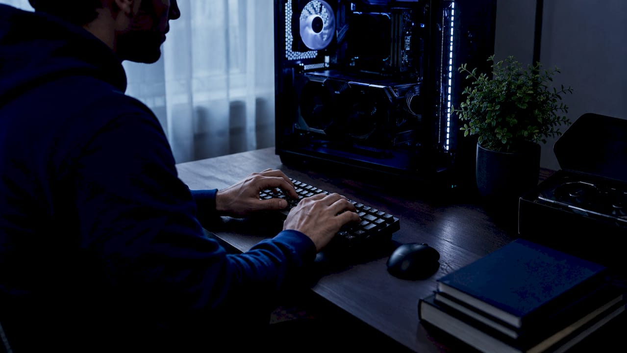 Hands typing near desktop showing GPU inside