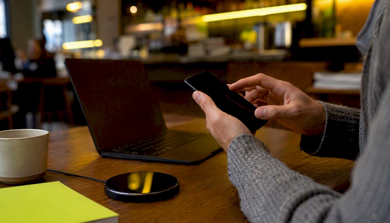 Hands adjusting payment settings on smartphone