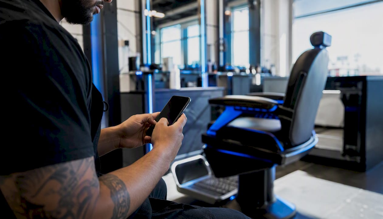 Barber holding phone confirming appointment