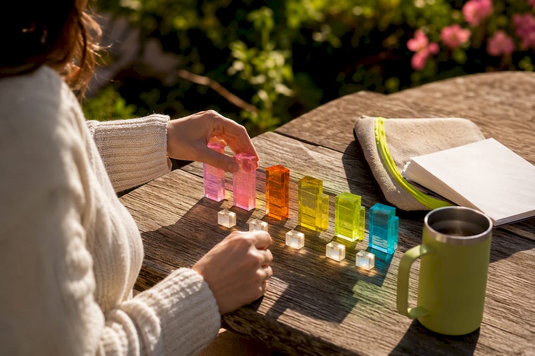 Hands arranging transparent data blocks on a table