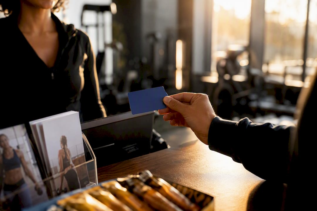 Gym membership card being swiped at front desk