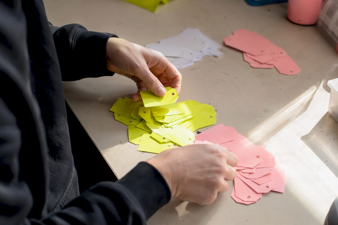 Hands organizing custom property tags