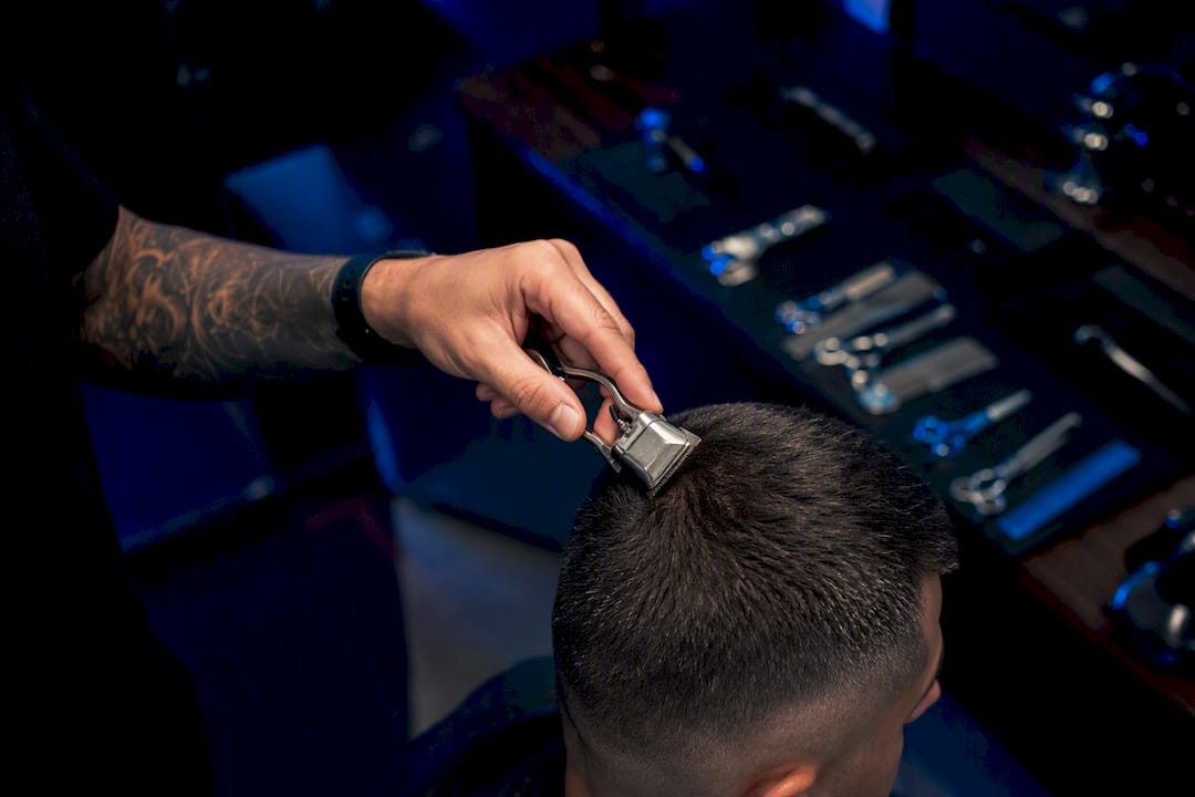 Close-up of barber cutting hair with clippers