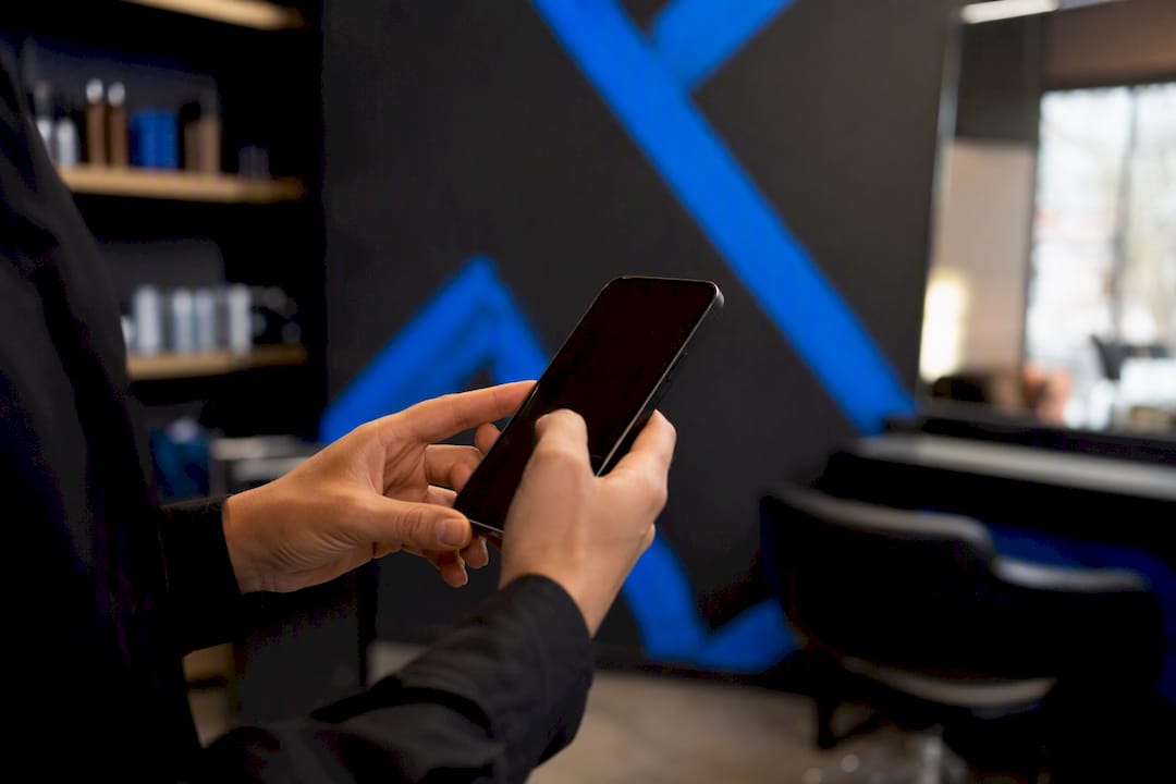 Hand tapping smartphone to confirm appointment