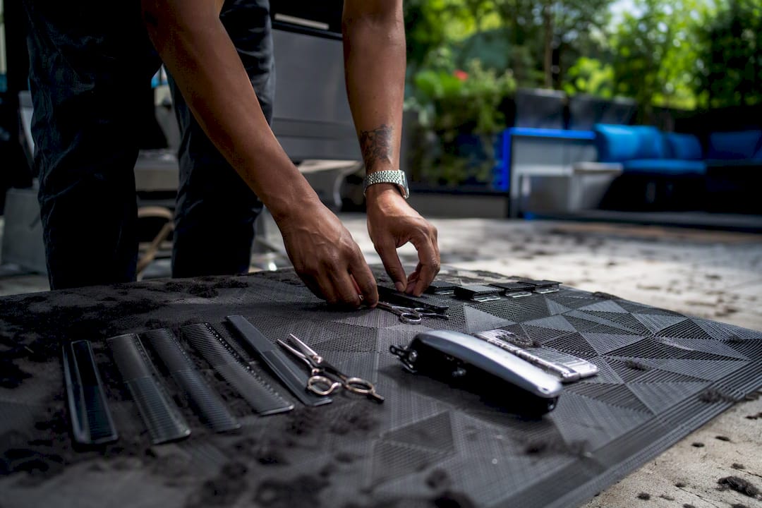 Barber arranging clean tools at station