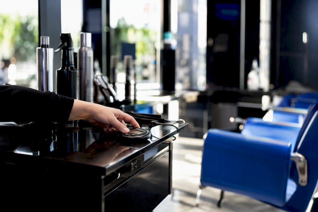 Stylist setting stopwatch for service timing