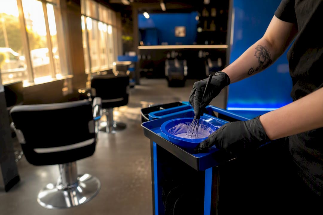 Stylist mixing hair color for service cycle