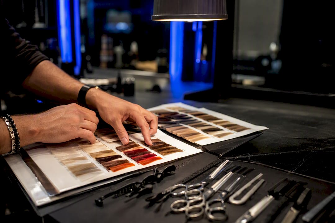 Stylist hands selecting hair color swatches