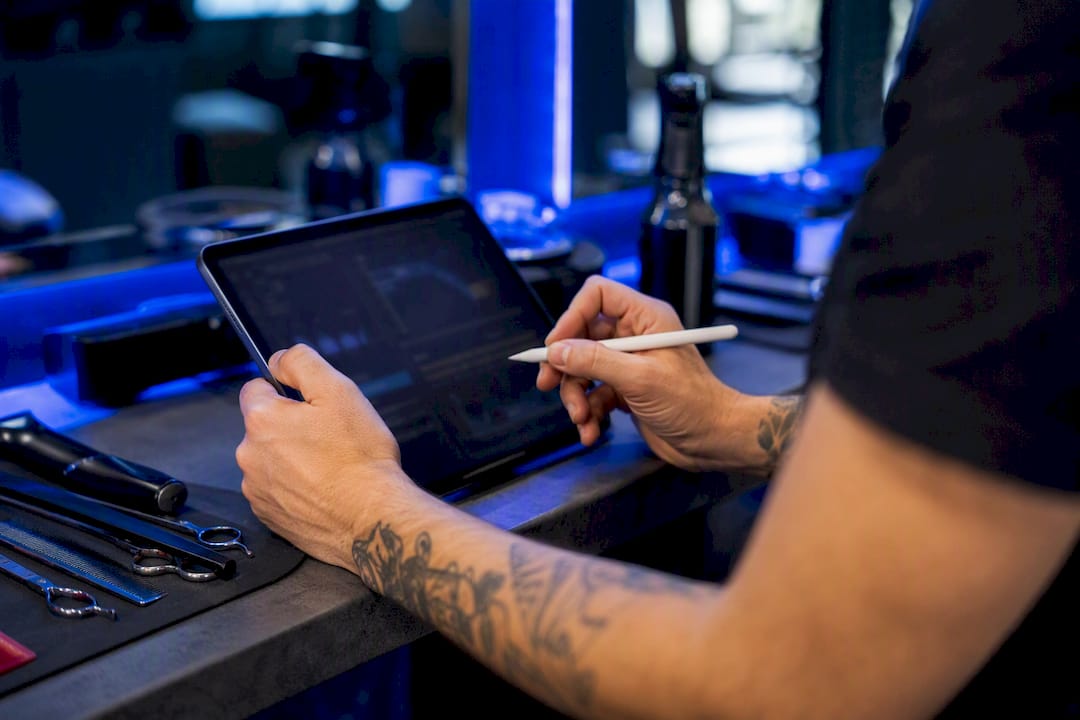 Hands interacting with tablet in salon