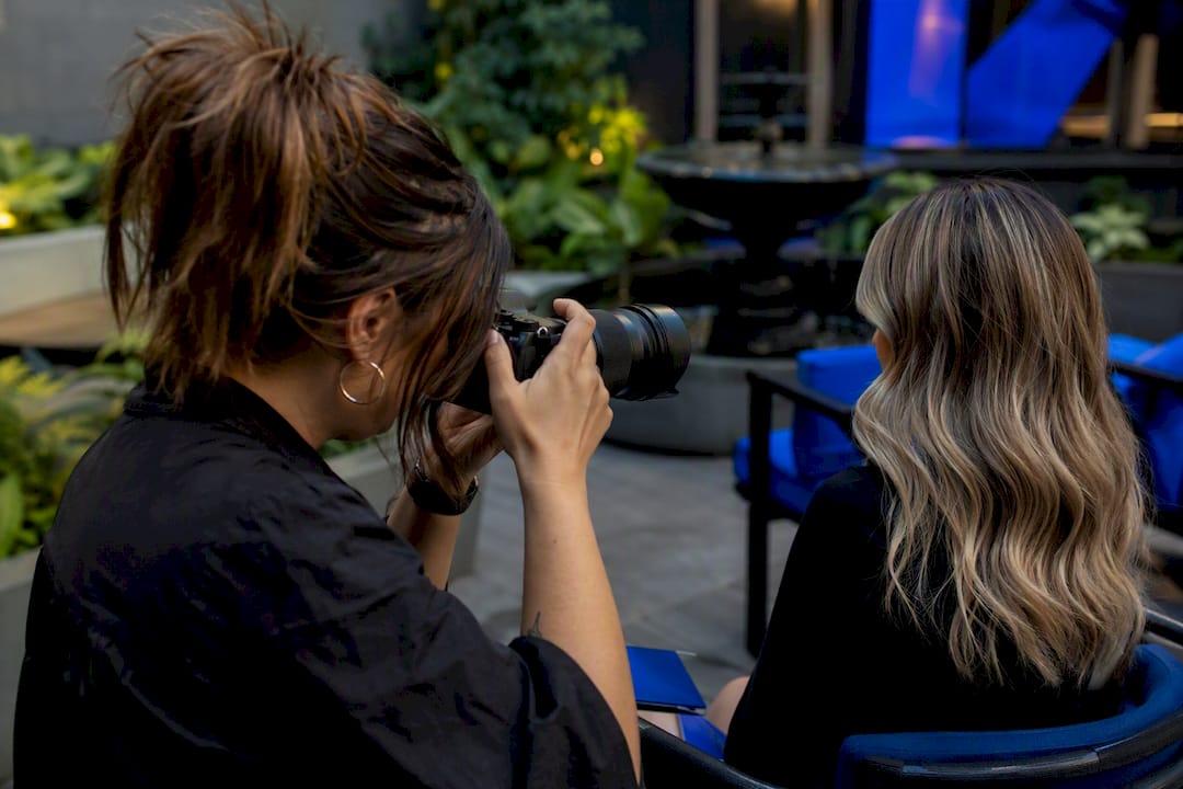Stylist photographing hair color portfolio
