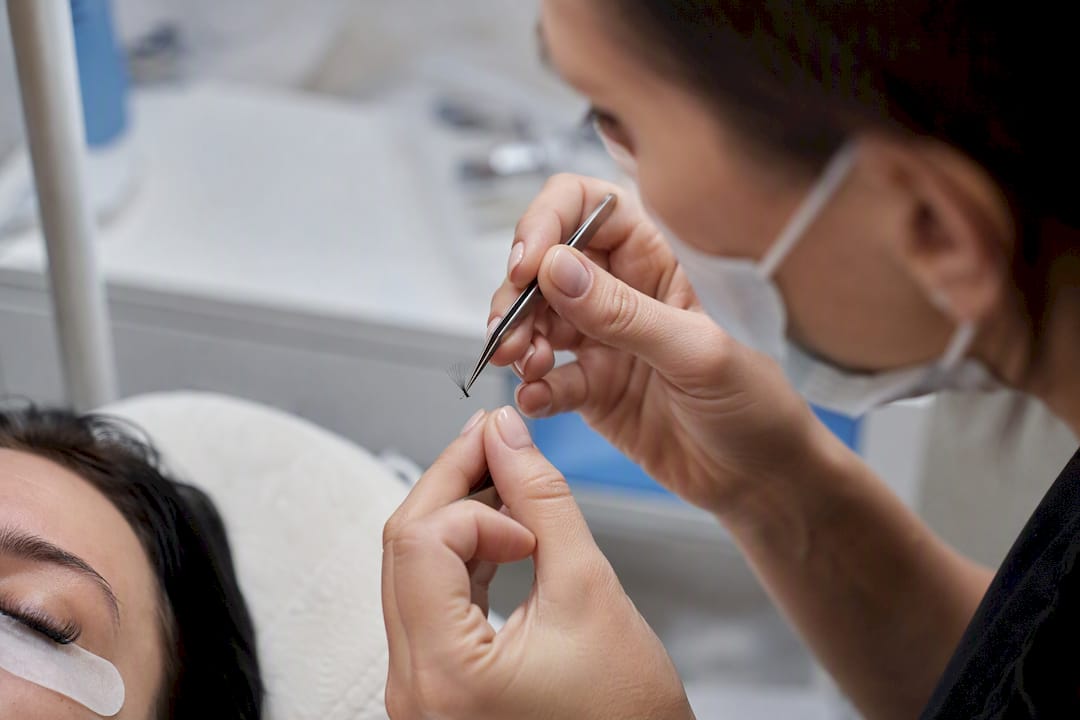 Hands holding volume fan lash extensions