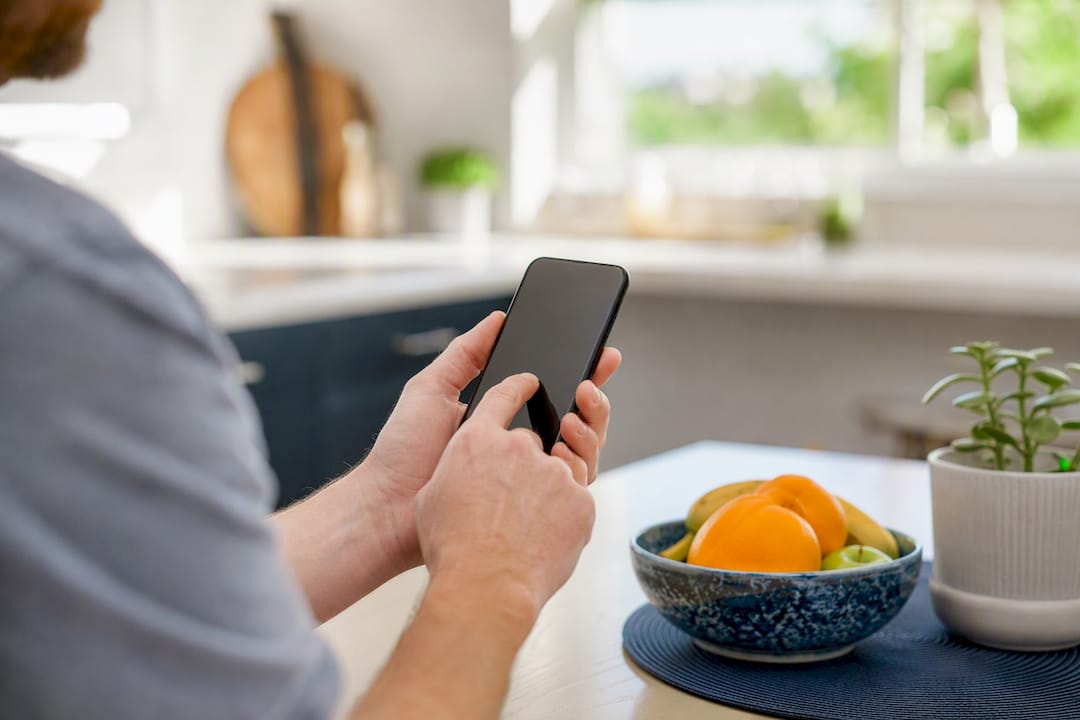 Hands holding tablet in home reviewing contractors
