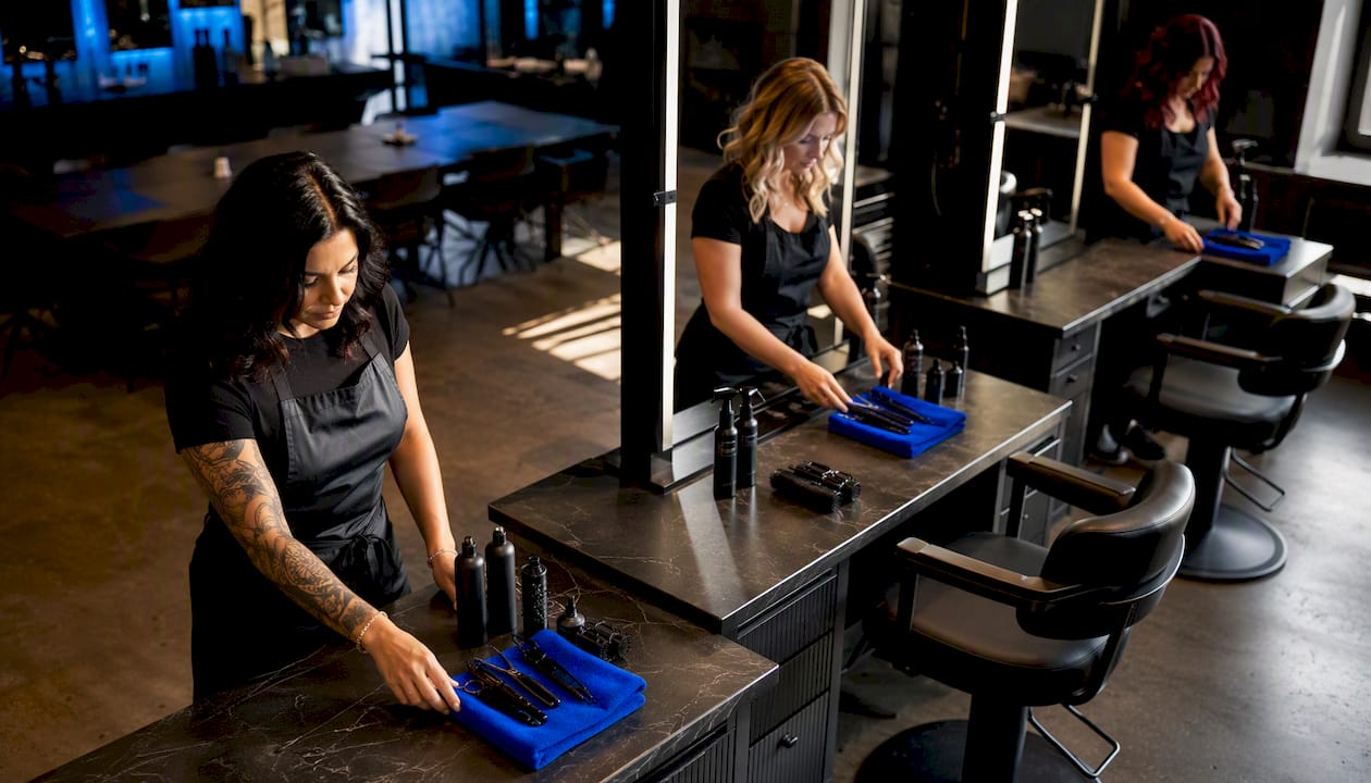 Stylists preparing coordinated salon stations