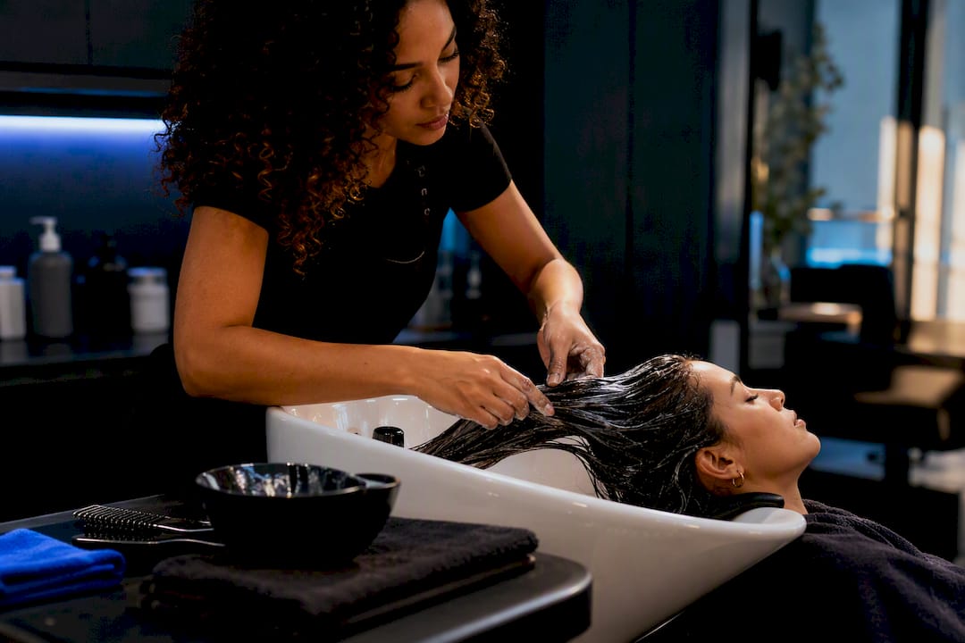 Stylist applying salon conditioning treatment