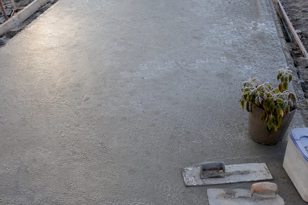 Frost-exposed concrete pavement surface close-up