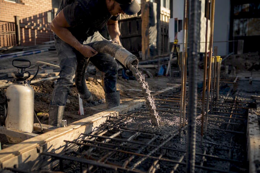 Concrete being poured around reinforcement bars