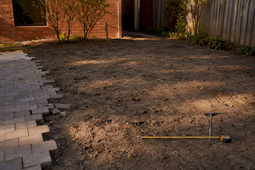 Probing cracked clay soil under paving site