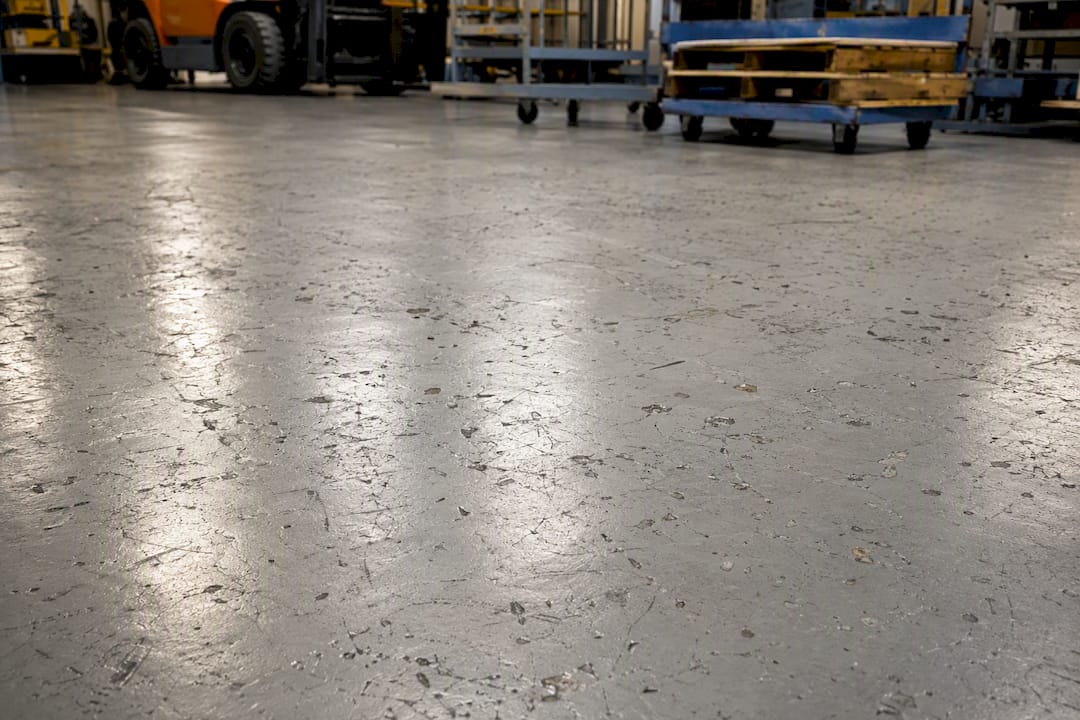 Worn industrial epoxy floor surface in workshop