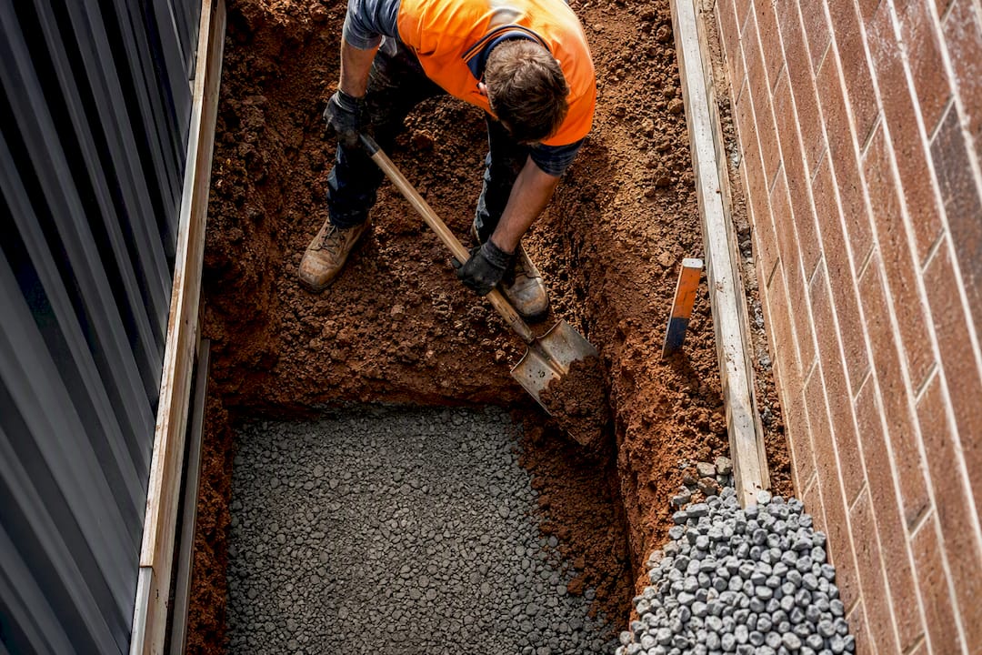 Excavated clay revealing concrete path sub-base