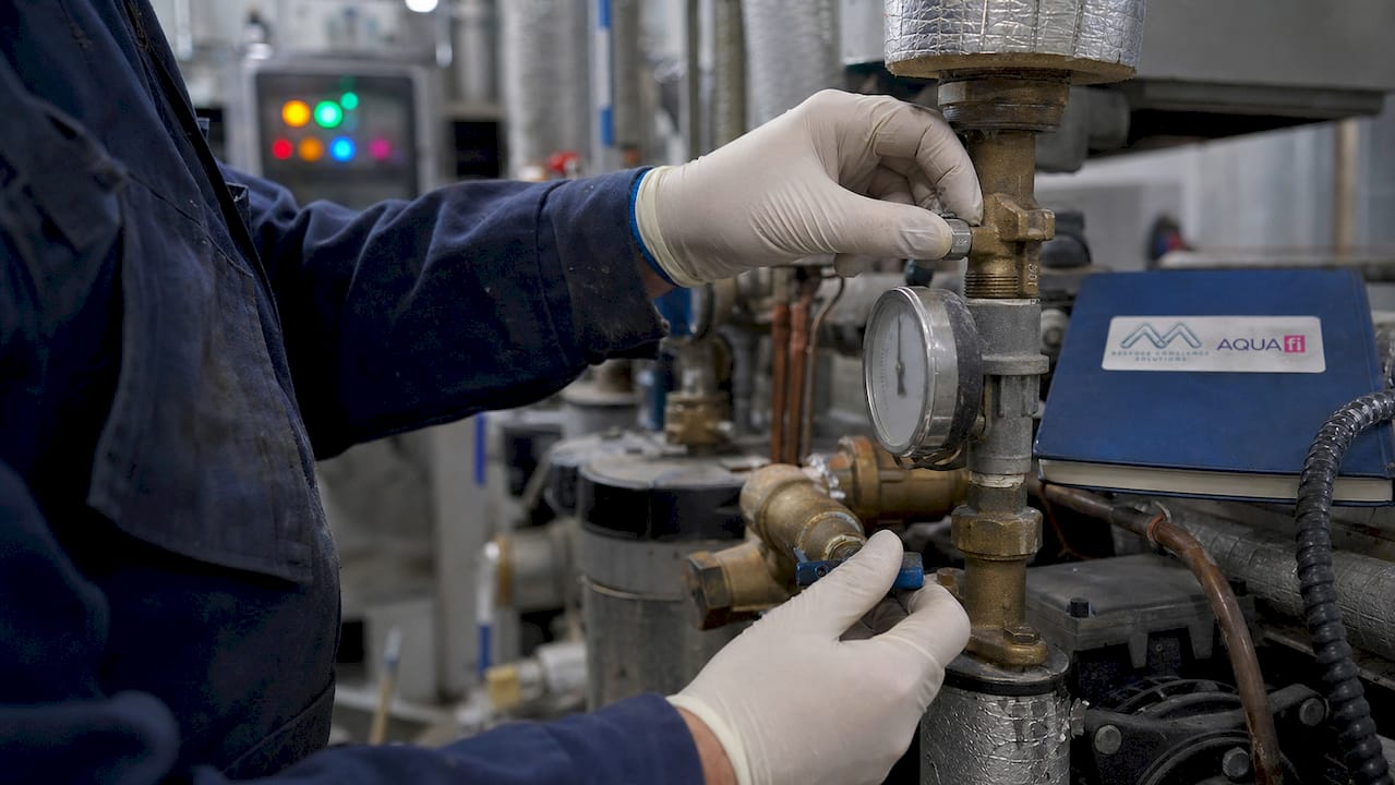Technician adjusting commercial water system valves