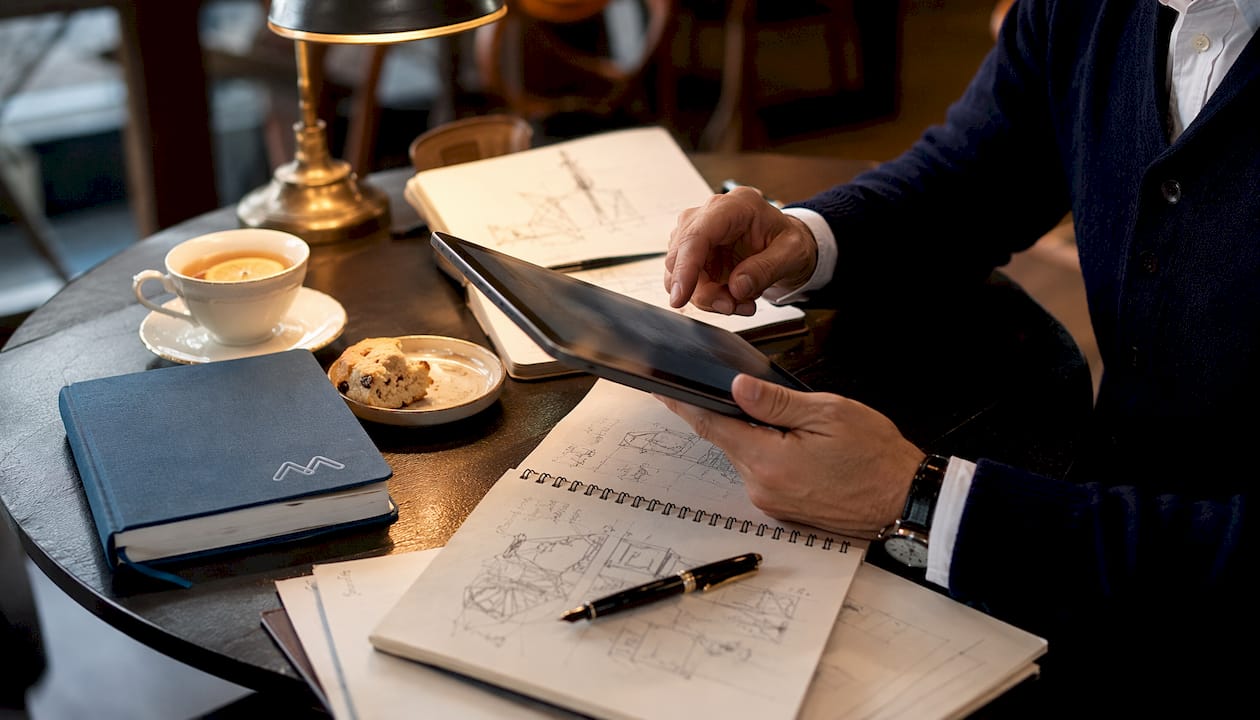 Hands interacting with digital compliance data on tablet