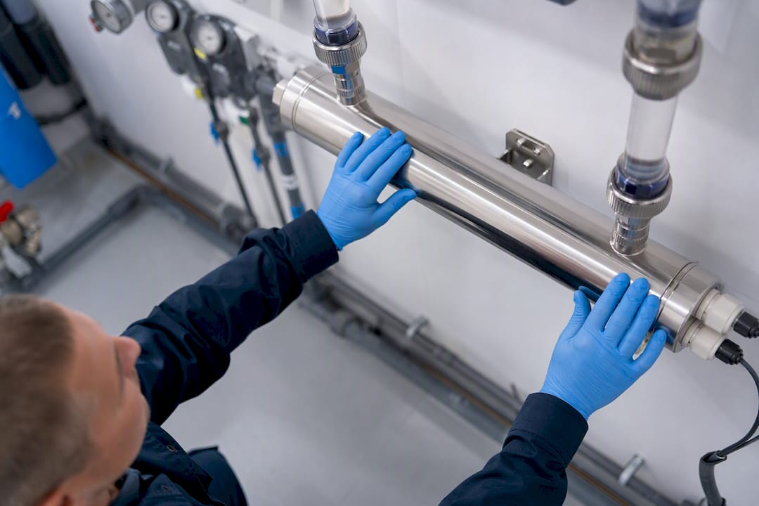 Hands adjusting UV disinfection reactor