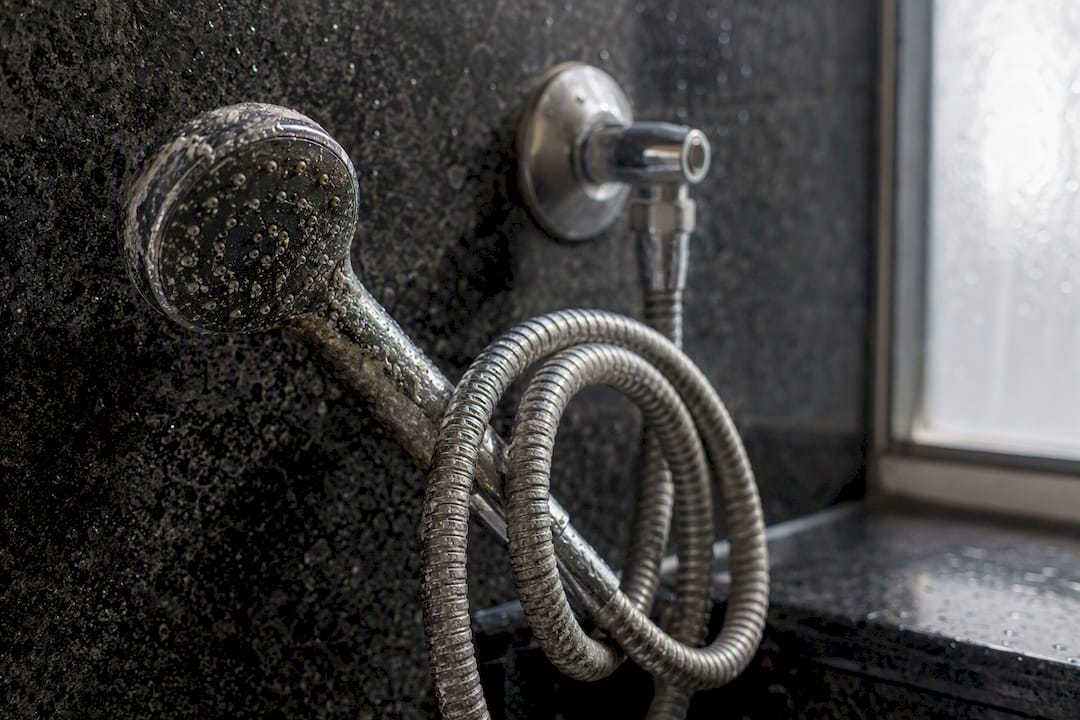 Close-up of scaled hotel shower hose