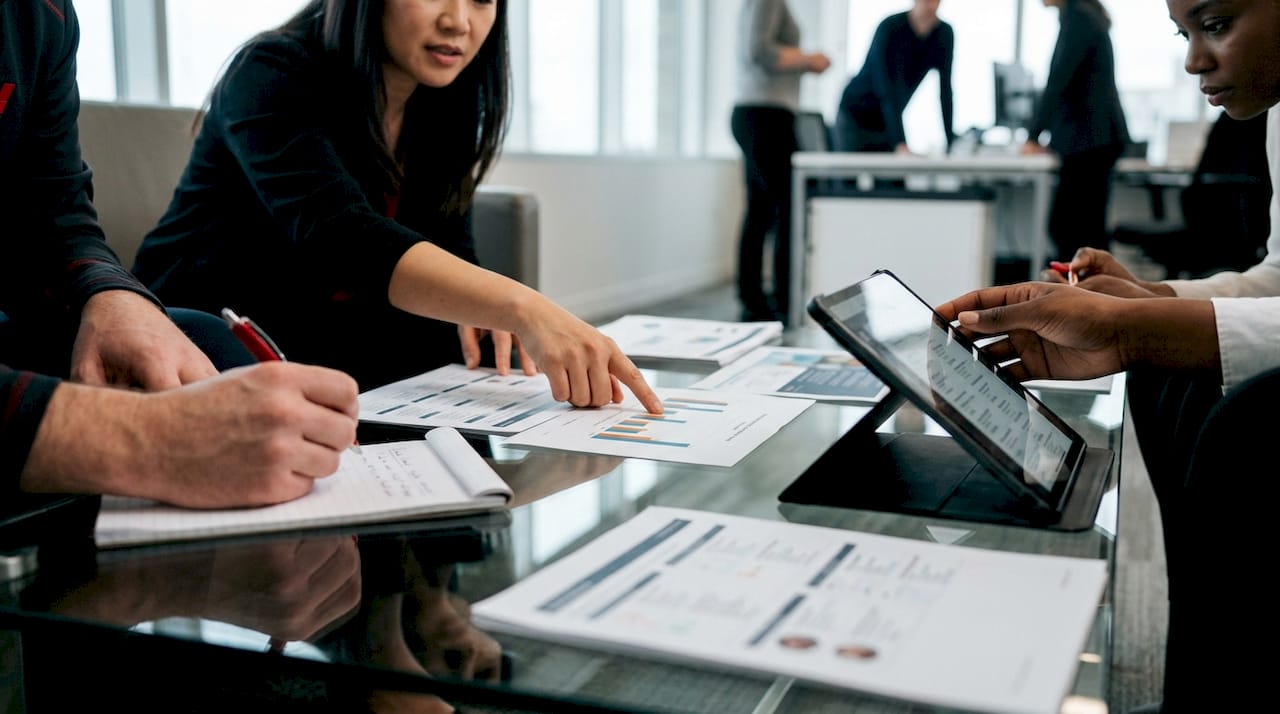 Hands reviewing third-party data for AI ranking