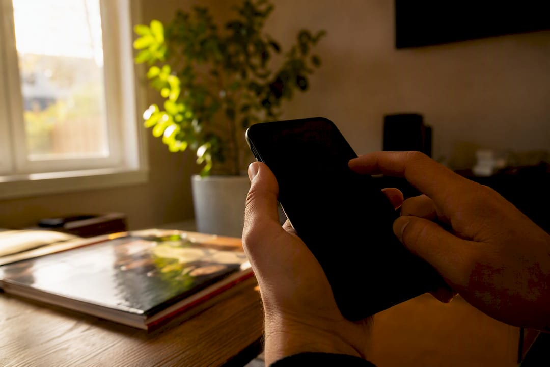 Hands holding smartphone interacting with estimator