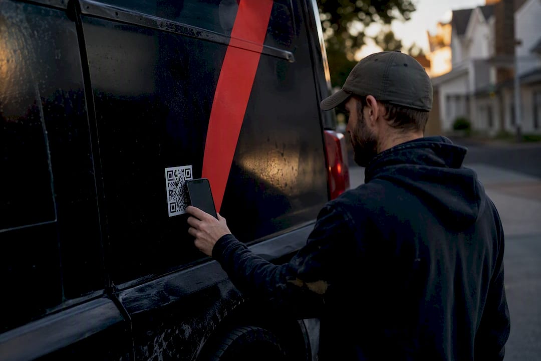 Contractor scanning QR code on truck wrap