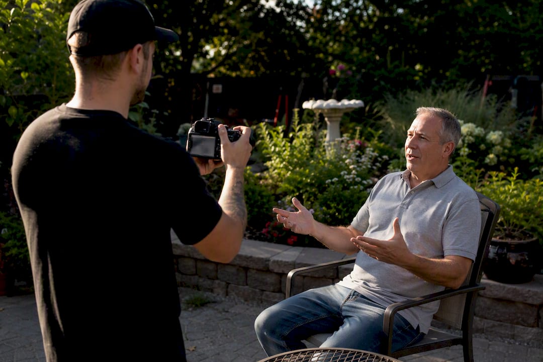 Contractor filming customer testimonial outdoors