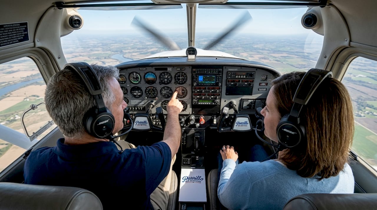Flight instructor teaching student controls in small plane