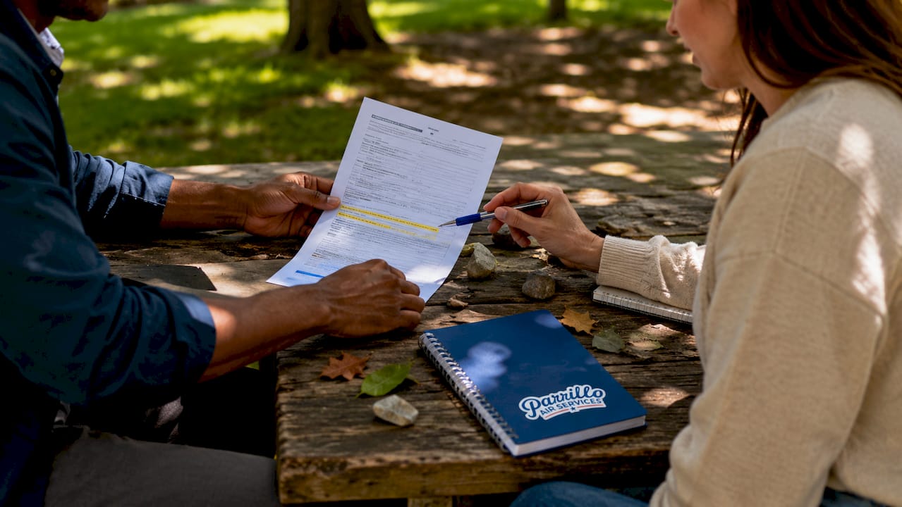 Close-up of hands reviewing flight school loan applications