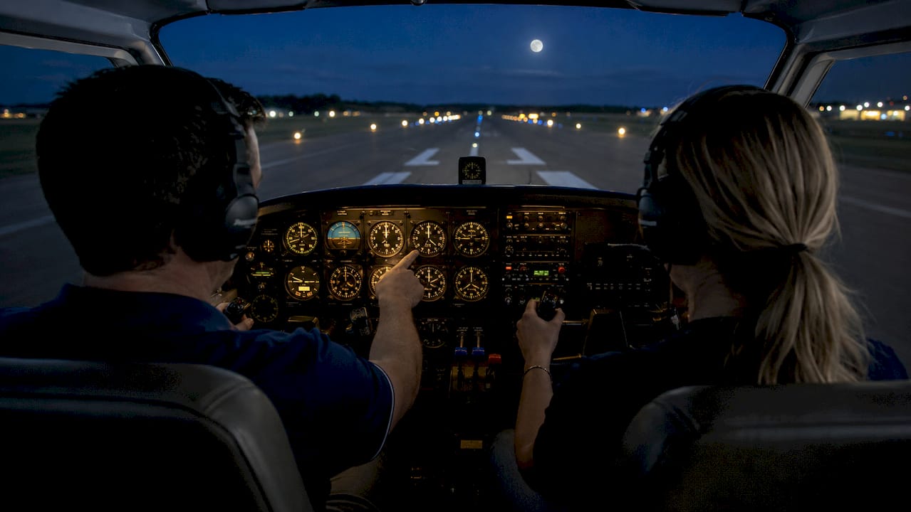 Instructor and student during night flight training cockpit session